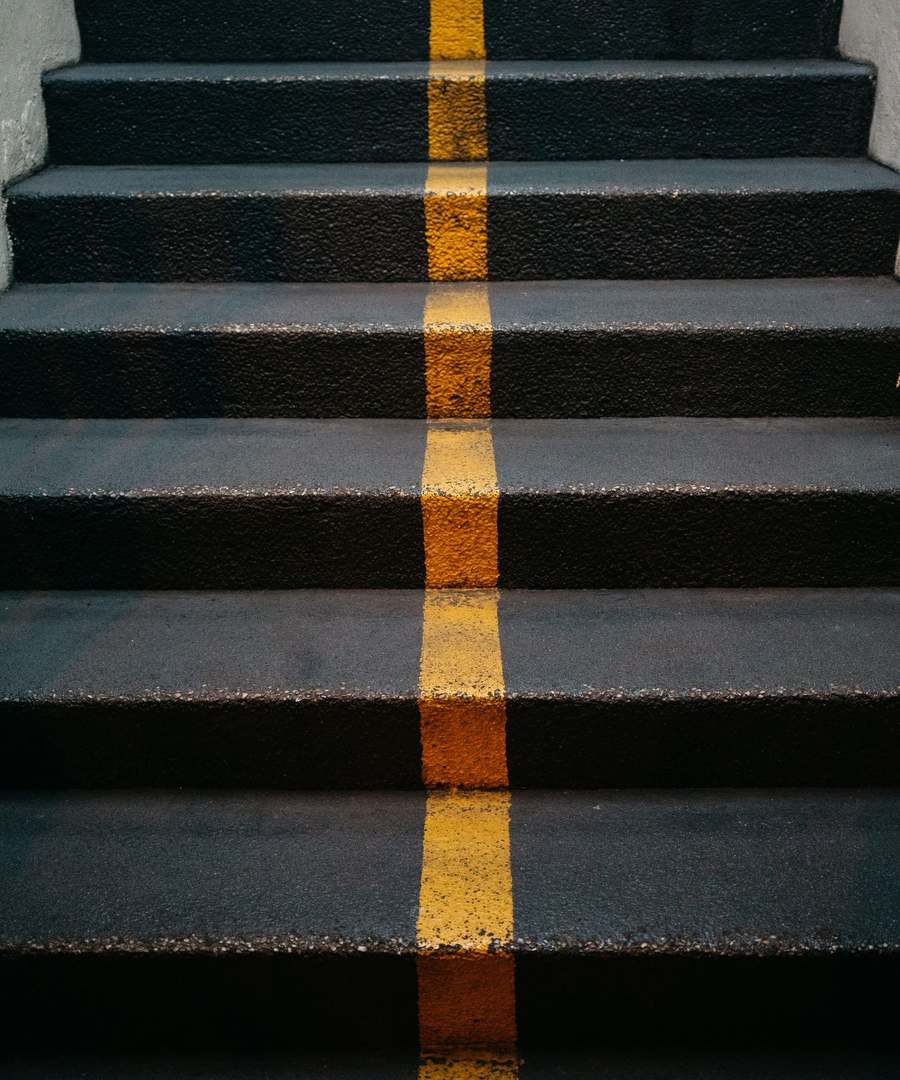 Concrete stairs with a yellow marking line running up the middle